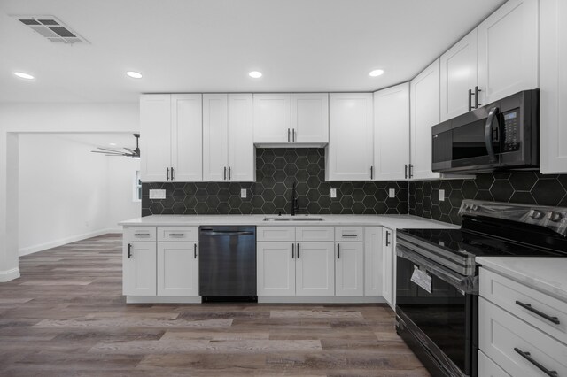 kitchen featuring white cabinets, sink, and black appliances