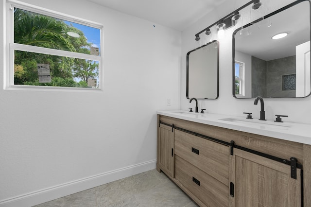 bathroom with tile patterned flooring, vanity, and a wealth of natural light