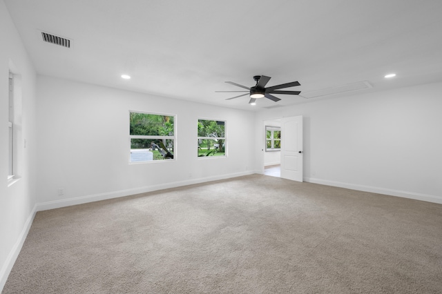 empty room featuring ceiling fan and light colored carpet