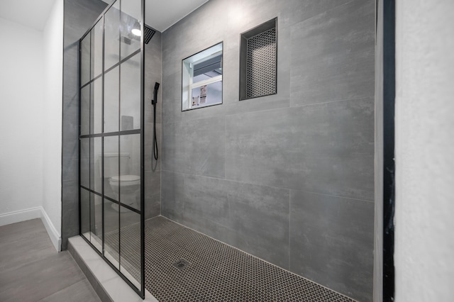 bathroom with a tile shower