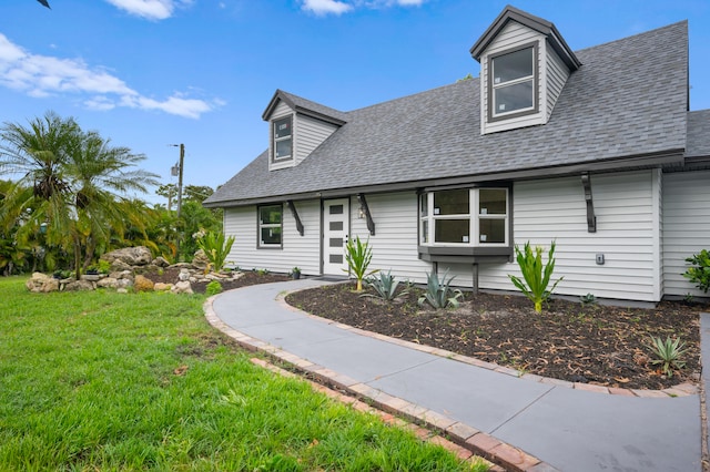 new england style home featuring a front yard