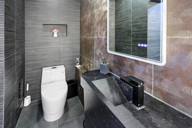 bathroom with tile walls, tile patterned floors, and toilet