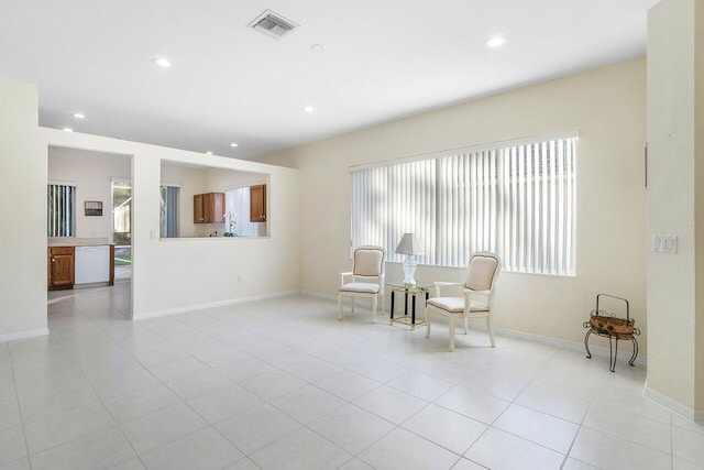 living area with a wealth of natural light and light tile patterned flooring