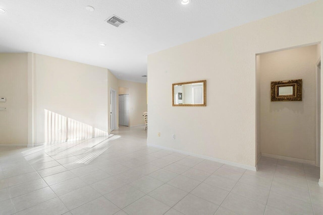 spare room featuring light tile patterned floors