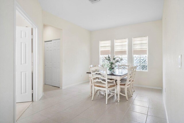 dining area featuring light tile patterned floors