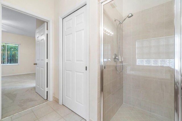 bathroom with tile patterned flooring and an enclosed shower