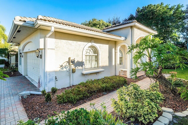 view of side of property featuring a garage