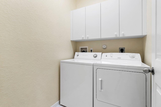 washroom with cabinets and separate washer and dryer