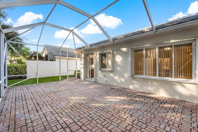 view of patio / terrace featuring a lanai