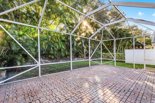 view of patio featuring a lanai