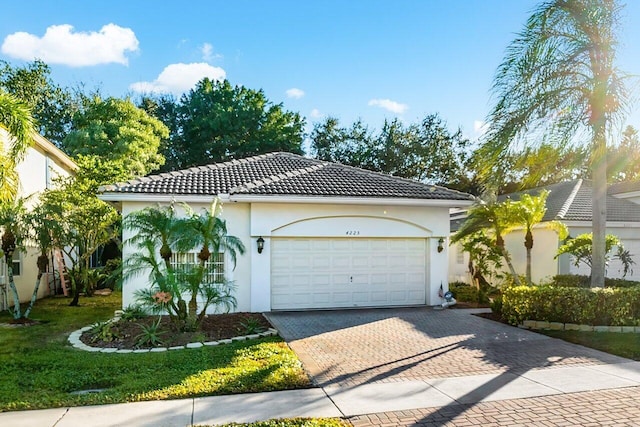 mediterranean / spanish-style house with a garage