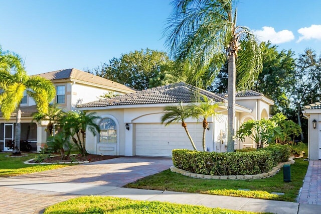 mediterranean / spanish-style home with a garage