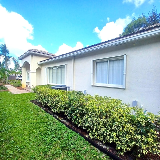 view of property exterior featuring a lawn