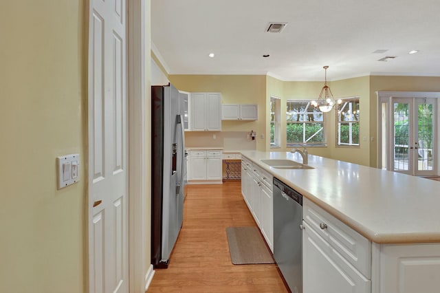 kitchen with white cabinets, plenty of natural light, an island with sink, and appliances with stainless steel finishes