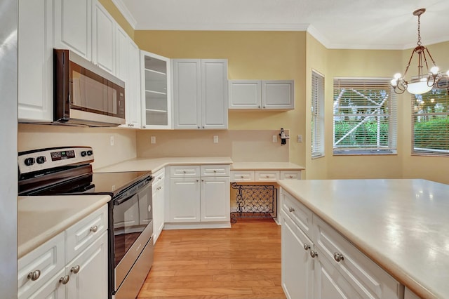 kitchen featuring a chandelier, white cabinetry, light hardwood / wood-style floors, and appliances with stainless steel finishes