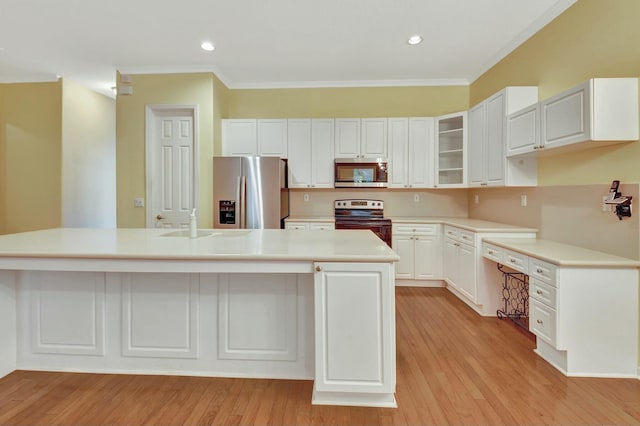 kitchen with a center island with sink, white cabinetry, stainless steel appliances, and light hardwood / wood-style flooring