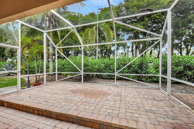 view of patio featuring glass enclosure