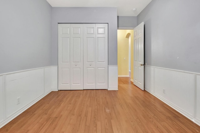 unfurnished bedroom featuring light hardwood / wood-style floors and a closet