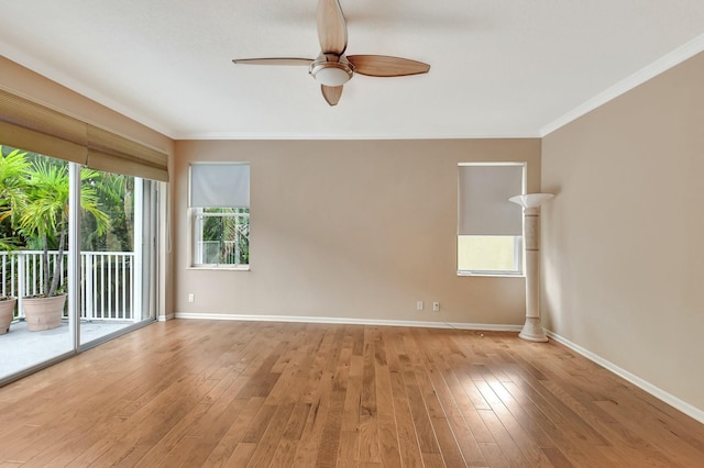 spare room featuring ceiling fan, ornamental molding, and light wood-type flooring