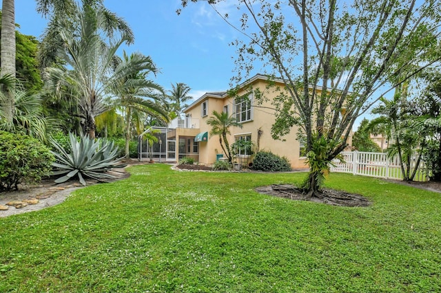 view of yard featuring a balcony and a lanai