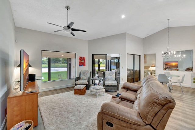 8306 Mooring Cir, Boynton Beach, FL 33472 - living room with a chandelier, wood finished floors, a ceiling fan, baseboards, and high vaulted ceiling