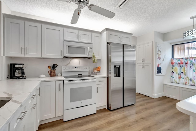 8306 Mooring Cir, Boynton Beach, FL 33472 - kitchen featuring white appliances, a textured ceiling, ceiling fan, light wood finished floors, and light stone counters