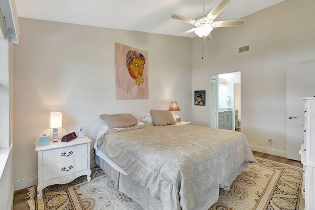 bedroom featuring ensuite bathroom, light wood-type flooring, and ceiling fan