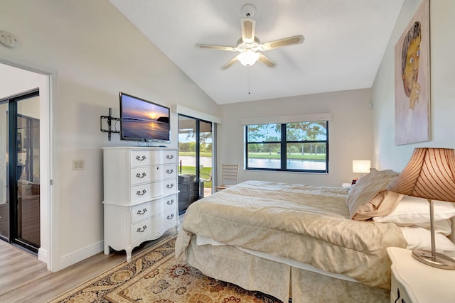 bedroom featuring ceiling fan, multiple windows, light hardwood / wood-style flooring, and vaulted ceiling