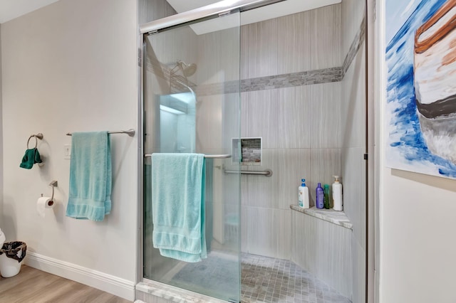 bathroom featuring an enclosed shower and hardwood / wood-style floors