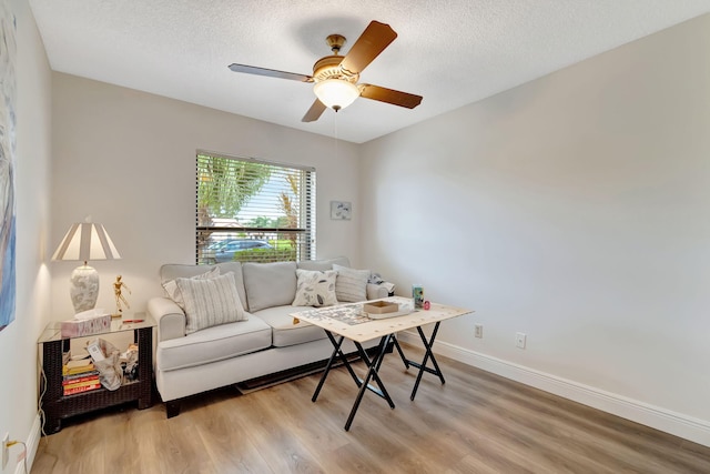 8306 Mooring Cir, Boynton Beach, FL 33472 - living area with light wood finished floors, baseboards, ceiling fan, and a textured ceiling