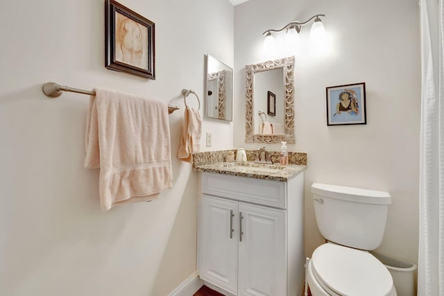 bathroom with toilet and vanity