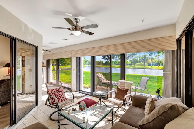 sunroom with a water view and ceiling fan