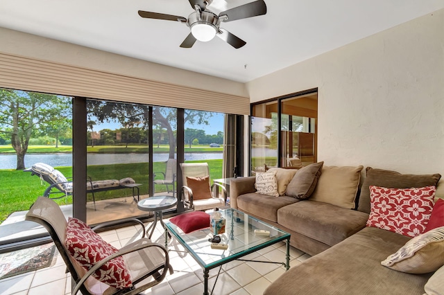 sunroom with a water view and ceiling fan