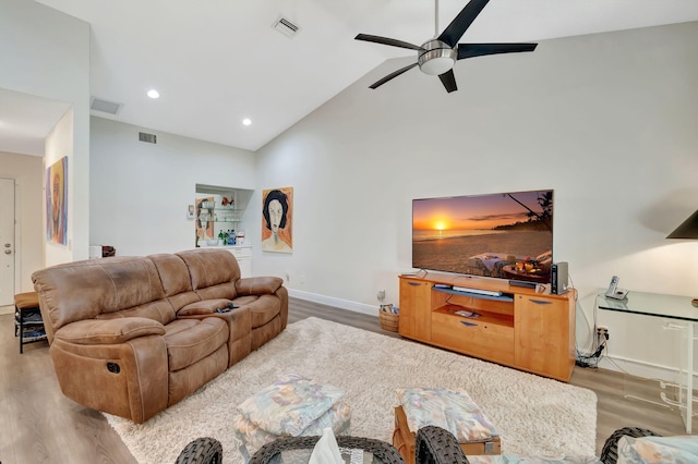 living room with high vaulted ceiling, light wood-type flooring, and ceiling fan