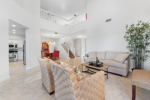 living room featuring light tile patterned flooring, a high ceiling, and an inviting chandelier