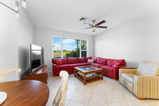 tiled living room with ceiling fan