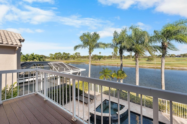 deck featuring an in ground hot tub and a water view