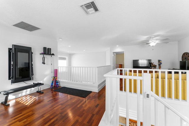 corridor with hardwood / wood-style flooring and a textured ceiling