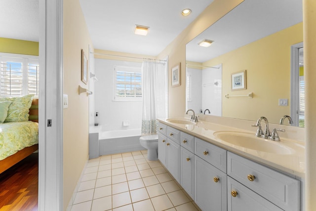 full bathroom with tile patterned floors, vanity, shower / bath combo, and toilet