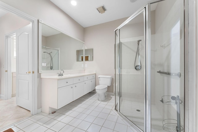 bathroom with toilet, vanity, tile patterned floors, and an enclosed shower