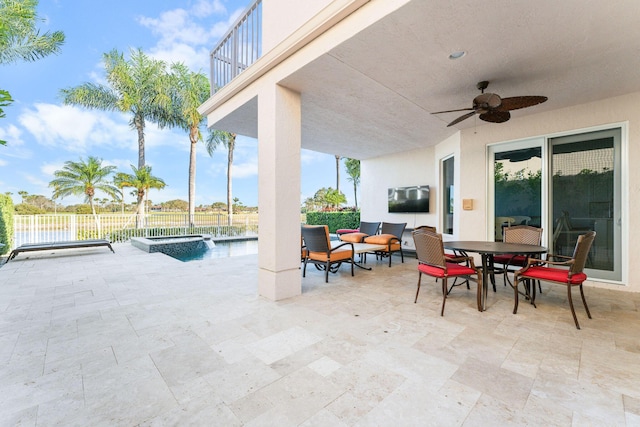 view of patio / terrace with an in ground hot tub, a balcony, and ceiling fan