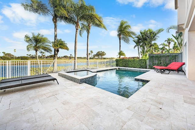 view of pool with a patio area, a water view, and an in ground hot tub