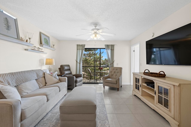 tiled living room featuring a textured ceiling and ceiling fan