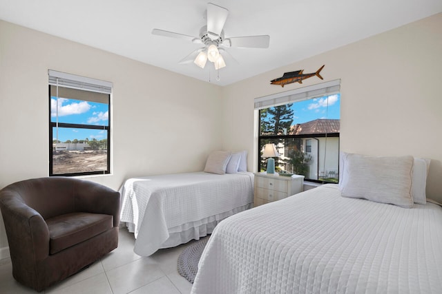 tiled bedroom with multiple windows and ceiling fan