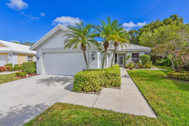 view of front of property featuring a garage and a front yard