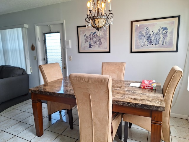 dining space with light tile patterned flooring, a chandelier, and a textured ceiling