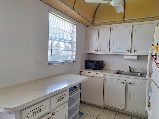 kitchen featuring white cabinetry, sink, ceiling fan, white appliances, and light tile patterned floors