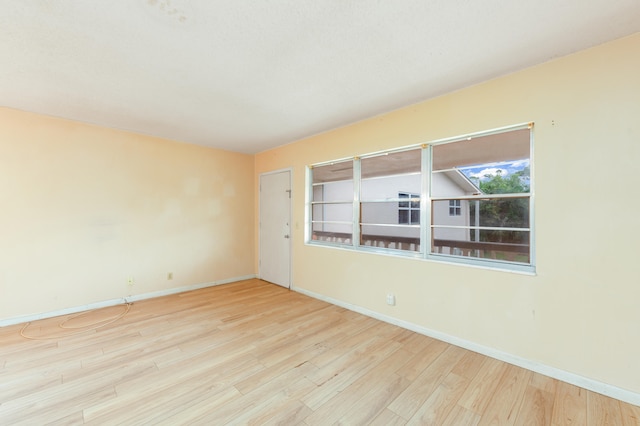 spare room with light hardwood / wood-style flooring