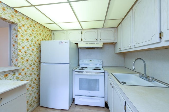 kitchen with white cabinets, white appliances, and sink