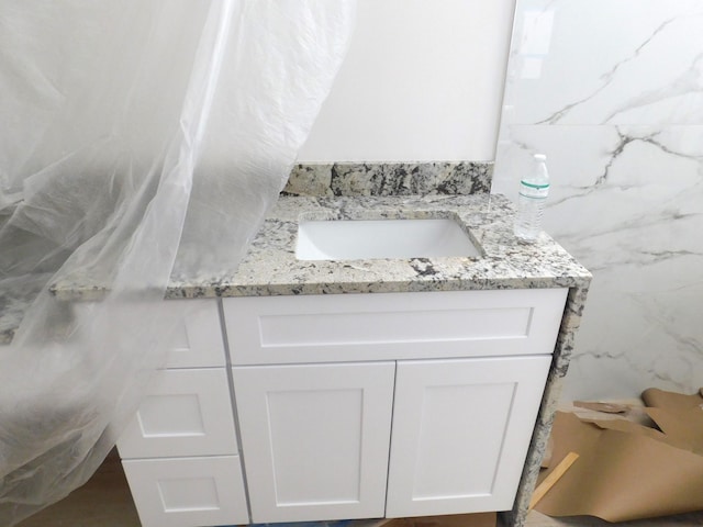 bathroom featuring vanity and tile walls